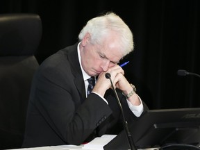 Commissioner Paul Rouleau rests on his hands as Prime Minister Justin Trudeau appears as a witnesses at the Public Order Emergency Commission in Ottawa, on Friday, Nov. 25, 2022.