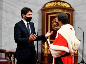 Prime Minister Justin Trudeau, left, speaks with Chief Justice Richard Wagner in the Senate chamber in Ottawa, in 2020.