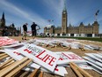 In this May photo, anti-abortion campaigners prepare for the annual National March for Life at the grounds of Parliament Hill.