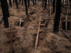 A photo taken on Sept. 25, 2022, shows empty holes after the exhumation of bodies from a mass grave created during the Russian army's occupation of Izyum, in Ukraine's Kharkiv region.