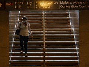 A commuter wears a mask while walking down the stairs at Union Station in Toronto on Friday, Sept. 16, 2022.&ampnbsp;Ontario doctors are advising that people wear masks indoors and keep up with vaccinations amid a worsening respiratory illness season that's hitting children particularly hard.&ampnbsp;THE CANADIAN PRESS/Alex Lupul