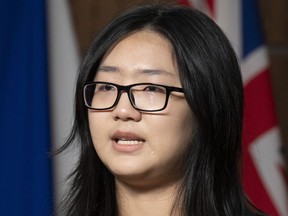 A tear rolls down her cheek as Katherine Dong speaks during a news conference for the release of her father Dong Guangping, on Parliament Hill, Thursday, November 17, 2022 in Ottawa.