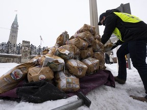 Bags of Prince Edward Island potatoes are unloaded from a transport truck in Ottawa on Dec. 8, 2021. One year after potato shipments to the United States were banned for four months, farmers in Prince Edward Island are feeling the impact of lost income and customers.
