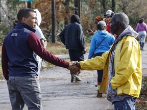 Montgomery, Ala., Mayor Steven Reed, left, speaks hands with Jefferey Jordan, right, Wednesday, Nov. 30, 2022, in Flatwood, Ala., who had damage to his home from a severe storm. Two people were killed in the Flatwood community just north of the city of Montgomery.