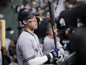 New York Yankees Aaron Judge stands in the dugout ahead of Game 1 of baseball's American League Championship Series between the Houston Astros and the New York Yankees, Wednesday, Oct. 19, 2022, in Houston.