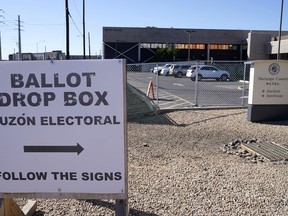 Signs direct voters to drop off their ballots at a secure ballot drop box at the Maricopa County Tabulation and Election Center in Phoenix, Monday, Oct. 31, 2022.