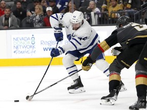 Toronto Maple Leafs defenseman Morgan Rielly (44) and Vegas Golden Knights defenseman Zach Whitecloud (2) vie for the puck during the first period of an NHL hockey game in Las Vegas, Monday, Oct. 24, 2022. The Toronto Maple Leafs' defence has taken another huge hit, with the team placing Morgan Rielly on long-term injured reserve with a knee injury.