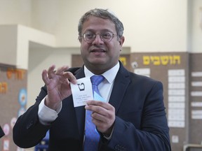 FILE - Israeli far-right lawmaker Itamar Ben Gvir shows his ballot in the West Bank settlement of Kiryat Arba during Israeli elections, Tuesday, Nov. 1, 2022. Ben Gvir, whose surging popularity helped propel former Prime Minister Benjamin Netanyahu back to power in last week's general election, delivered a glowing tribute Thursday, Nov. 10, at a memorial event for an extremist rabbi assassinated in 1990.