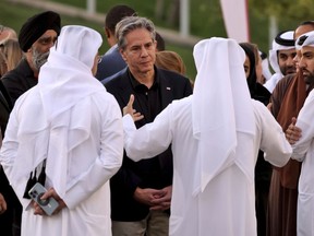U.S. Secretary of State Anthony Blinken listens to officials during a visit to Oxygen Park at Education City, in Doha Qatar, Monday, Nov. 21, 2022.