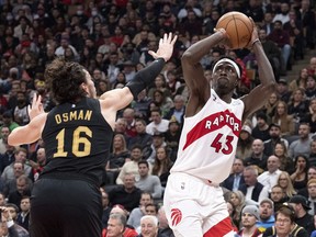 Toronto Raptors' Pascal Siakam, right, scores on Cleveland Cavaliers' Cedi Osman during first half NBA basketball action in Toronto, Monday, Nov. 28, 2022.&nbsp;Back after a 10-game absence, Siakam scored Toronto's first points of the game en route to 18 points and 11 rebounds to help the Raptors to a 100-88 win over the Cleveland Cavaliers on Monday.