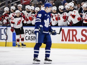 New Jersey Devils celebrate after teammate Nico Hischier (13) scored during second period NHL hockey action against the Toronto Maple Leafs, in Toronto, Thursday, Nov. 17, 2022.