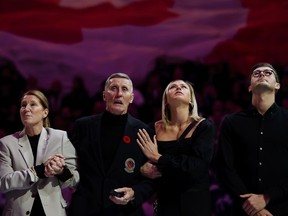 Former Toronto Maple Leaf Borje Salming, joined by his wife Pia Salming (left) and family members, is honoured during a pregame ceremony prior to NHL hockey action between the Toronto Maple Leafs and the Vancouver Canucks, in Toronto on Saturday, Nov. 12, 2022.