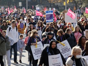 CUPE Ontario members and supporters wave demonstrate outside of the Queen's Park Legislative Building in Toronto, Friday, Nov. 4, 2022.