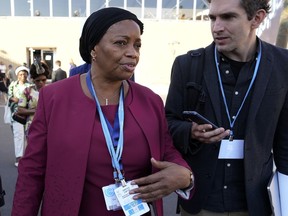 Eve Bazaiba, left, deputy prime minister and minister for the environment for Congo, walks through the venue of the COP27 U.N. Climate Summit, Friday, Nov. 18, 2022, in Sharm el-Sheikh, Egypt.