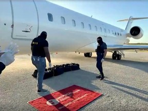 Video released by the Dominican Republic authorities shows law enforcement officers going through what is allegedly the cocaine seized on a Canadian chartered airliner in April. The Canadian flight crew were detained for months despite video evidence showing they were not involved.