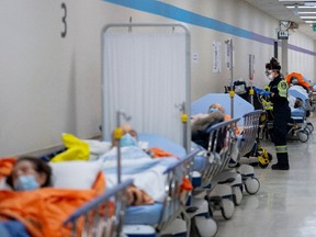 Paramedics transfer patients to the emergency room triage but have no choice but to leave them in the hallway due to an at capacity emergency room at the Humber River Hospital  January 25, 2022.