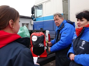 Dr. Christian Carrer and his partner Tetyana Grebenchykova, heads of the organization AICM, give a special emergency kit bag for first respondents to Paulina, an emergency room manager in the region of Balakliya, recently liberated by the Ukrainian army, on Friday Nov. 25, 2022.