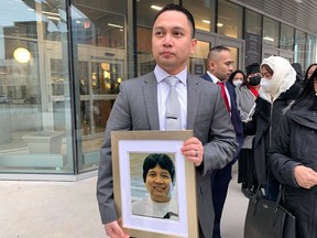 Edward Balaquit holds a picture of his father Eduardo Balaquit outside the Winnipeg Law Courts after a sentencing hearing for Kyle Pietz on Wednesday Nov. 9, 2022. Pietz was found guilty of manslaughter in the death and disappearance of Balaquit.