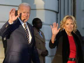 President Joe Biden and first lady Jill Biden wave as they walk to Marine One on the South Lawn of the White House, Monday, Nov. 21, 2022, in Washington. The Bidens are en route to North Carolina.