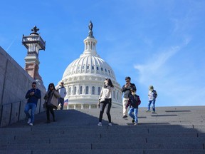 With the U.S Capitol in the background, people walk down steps on Election Day in Washington, Tuesday, Nov. 8, 2022.
