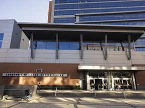 People walk in and out of the Leonard L. Williams Justice Center in Wilmington, Del., Monday, Nov. 14, 2022. Testimony is under way in a shareholder lawsuit challenging approval by Tesla's board of directors of a compensation plan potentially worth more than $55 billion for CEO Elon Musk.