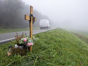 A wooden memorial cross stands at the spot where two police officers were killed in the line of duty at the end of January 2022 near the town Kusel, Germany, Tuesday, Nov. 29, 2022 . A court convicted a 39-year-old man of murder on Wednesday, Nov. 30, 2022, in the killing of two police officers who had stopped him and an accomplice on suspicion of poaching. A regional court in Kaiserslautern sentenced the defendant to life imprisonment.
