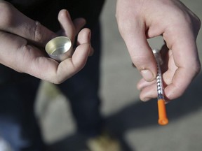 A fentanyl user holds a needle near Kensington and Cambria in Philadelphia, on Oct. 22, 2018. Toronto Public Health is issuing a drug alert after a spike in suspected fatal overdoses.THE CANADIAN PRESS/David Maialetti-The Philadelphia Inquirer via AP