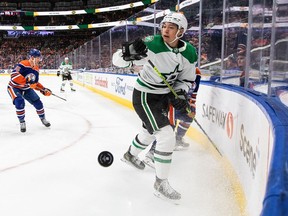 Dallas Stars' Jason Robertson (21) and Edmonton Oilers' Derek Ryan (10) battle for there puck during first period NHL action in Edmonton, Saturday, Nov. 5, 2022.&ampnbsp;The 23-year-old sat atop the NHL goal-scoring race with 19, two ahead of Connor McDavid and Bo Horvat, before the puck dropped across the league Wednesday night.
