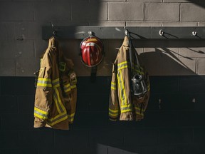 Firefighter protection gears hanging on the wall of the fire station