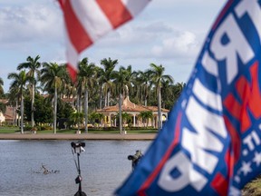 Flags in support of former President Donald Trump fly outside his Mar-a-lago resort, Tuesday, Nov. 15, 2022 in Palm Beach, Fla. Trump is preparing to launch his third campaign for the White House with an announcement Tuesday night.