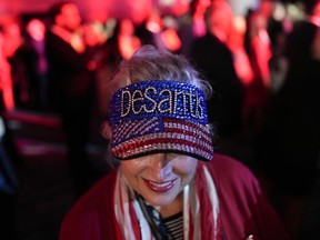 A woman arrives before Incumbent Florida Republican Gov. Ron DeSantis speaks to supporters during an election night party in Tampa, Fla., Tuesday, Nov. 8, 2022.
