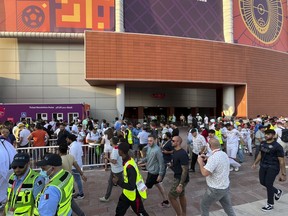Fans arrive for the World Cup group B soccer match between England and Iran at the Khalifa International Stadium Doha, Qatar, Monday, Nov. 21, 2022. Problems with FIFA's mobile application for World Cup match tickets have delayed fans from getting into the stadium to watch England play Iran in the second game of the tournament. Hundreds of fans were lined up outside the Khalifa International Stadium less than an hour before the 4 p.m. kickoff in Doha.