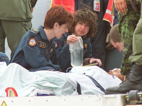 Medics prepare to move Sgt. Lorne Ford out of a military plane that landed at the Edmonton International Airport on April 23, 2002. - Christine Vanzella /Edmonton Sun