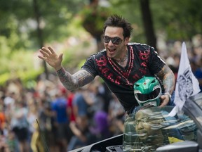FILE - Jason David Frank waves to the crowd as he makes his way down Peachtree Street in the annual DragonCon parade through downtown Atlanta, on Aug. 31, 2013. Frank, who played the Green Power Ranger Tommy Oliver on the 1990s children's series "Mighty Morphin Power Rangers," has died, according to a statement Sunday, Nov. 20, 2022, from his manager, Justine Hunt. He was 49.
