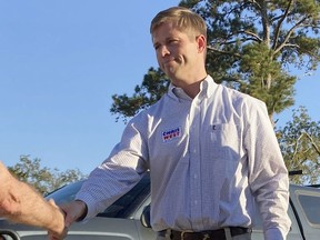 FILE - Republican Chris West, is shown in this file photograph, shaking hands with a voter on Oct. 6, 2022 at a campaign fundraiser in Georgetown, Ga. West is seeking Georgia's 2nd Congressional District seat.