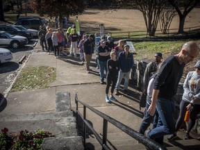 Voters wait in a growing line to cast their ballots at the Bessie Branham Park polling location on Sunday, Nov. 27, 2022, in Atlanta. The extended Senate campaign in Georgia between the Democratic incumbent, Raphael Warnock, and his Republican challenger, football legend Herschel Walker, has grown increasingly bitter as their Dec. 6 runoff nears.