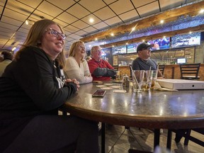 Tanya, left to right, Sharron, Rick and Kevin Schroeter watch game four of the World Series at Antonio's Pizza in Corunna, Ont., Wednesday, Nov. 2, 2022. There's a new rooting interest in the border town of Corunna, Ont., and surrounding area. The Phillies are getting the love now that local skipper Rob Thomson has guided Philadelphia to the World Series.