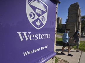 Students walk across campus at Western University in London, Ont., Saturday, Sept. 19, 2020.&ampnbsp;Faculty members at Western University may walk off the job next week if a last-minute deal is not reached with the school, the union representing them said Thursday.