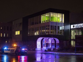 A police cruiser is shown outside College Montmorency in Laval, Que., Friday, November 11, 2022, where three people were shot in a park close to the college.