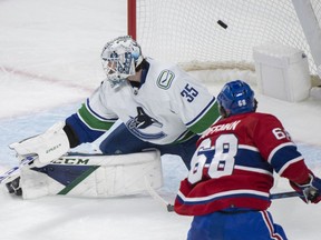 Montreal Canadiens' Mike Hoffman (68) scores against Vancouver Canucks goaltender Thatcher Demko during second period NHL hockey action in Montreal, Wednesday, November 9, 2022.