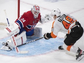 Montreal Canadiens goaltender Jake Allen makes a save against Philadelphia Flyers' Morgan Frost during second period NHL hockey action in Montreal, Saturday, November 19, 2022.