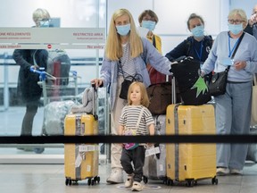 Ukrainian nationals fleeing the ongoing war in Ukraine arrive at Trudeau Airport in Montreal, Sunday, May 29, 2022. Government statistics show that fewer than a third of Ukrainians approved for temporary Canadian visas have arrived in the country as a backlog of applications continues.THE CANADIAN PRESS/Graham Hughes