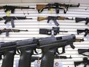 Assorted assault weapons and hand guns are seen in a U.S. store.