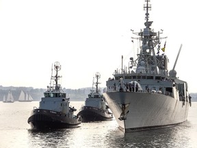 The HMCS Fredericton, guided by tugs, returns to Halifax, after completing a six-month deployment in the Mediterranean Sea, on Tuesday, July 28, 2020.
