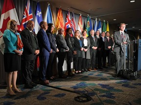 B.C. Health Minister Adrian Dix, front right, stands in front of health ministers from the other provinces and territories during a news conference after the first of two days of meetings, in Vancouver, on November 7, 2022.