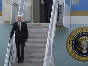 U.S. President Joe Biden smiles as he arrives on Air Force One for the Association of Southeast Asian Nations (ASEAN) summit in Phnom Penh, Cambodia, Saturday, Nov. 12, 2022.