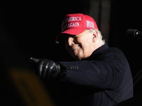 Former President Donald Trump reacts to a supporter during a rally, Thursday, Nov. 3, 2022, in Sioux City, Iowa.