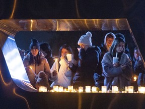 Boise State University students, along with people who knew the four University of Idaho students who were found killed in Moscow, Idaho, days earlier, pay their respects at a vigil held in front of a statue on the Boise State campus, Thursday, Nov. 17, 2022, in Boise, Idaho. Autopsies performed on the four students who were found dead inside a rental house near campus showed that all four were stabbed to death, the Latah County coroner said.