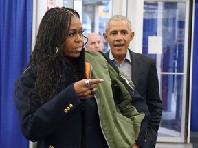 Former first lady Michelle Obama, left, and former President Barack Obama arrive to cast their ballots at an early voting site Monday, Oct. 17, 2022, in Chicago.