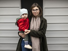 Inna Fomina, who came to Canada to take refuge from the war in Ukraine, stands with her son Adrian Derevianko, 10-month-old, outside their home in Ottawa, on Monday, Oct. 31, 2022.